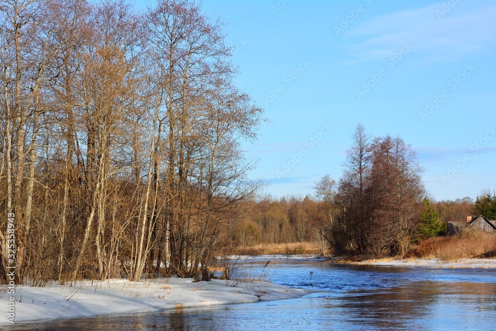 Reflection of a spring forest in a wide river Reflection of a spring forest in a wide river