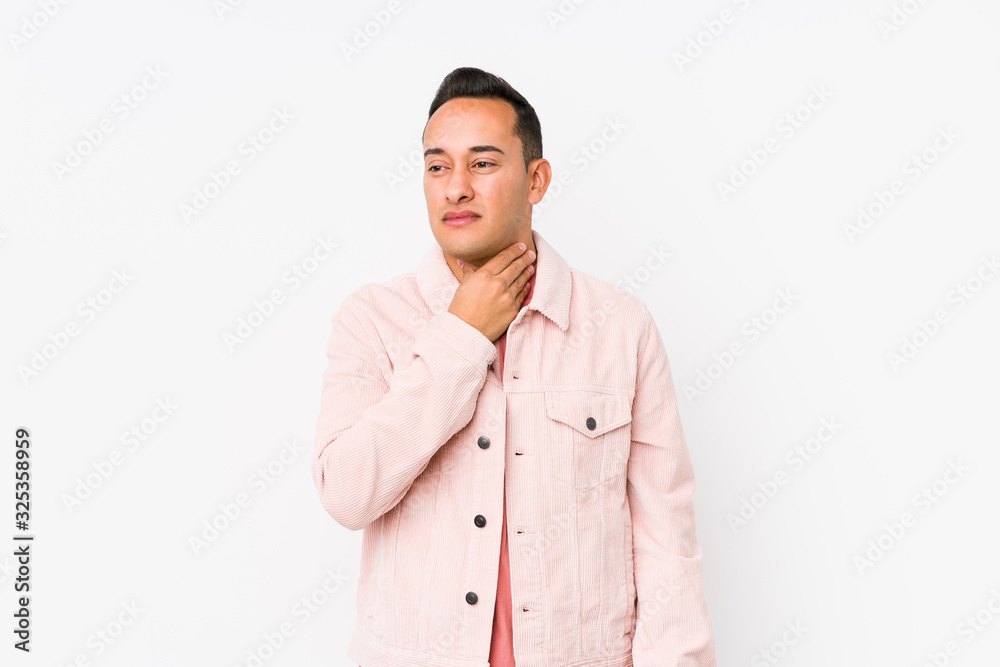 Young latin man posing isolated suffers pain in throat due a virus or infection. Young latin man posing isolated suffers pain in throat due a virus or infection.