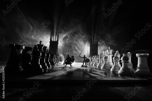 Chess board game concept of business ideas and competition and strategy ideas Chess figures on a dark background with smoke and fog.