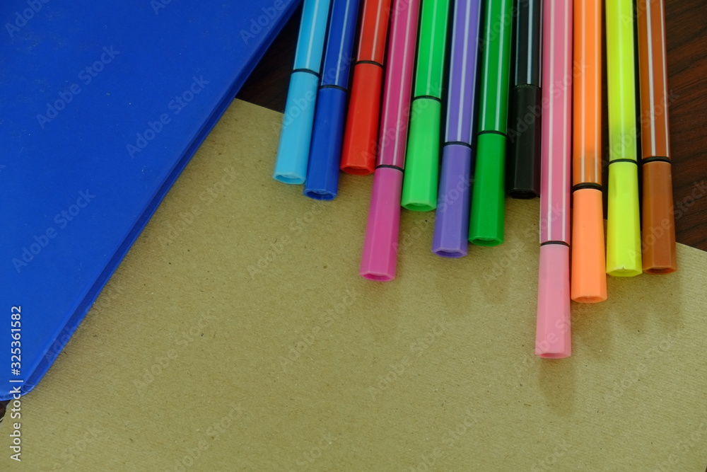 Back to school background with books, pencils colorful on wooden table classroom.
