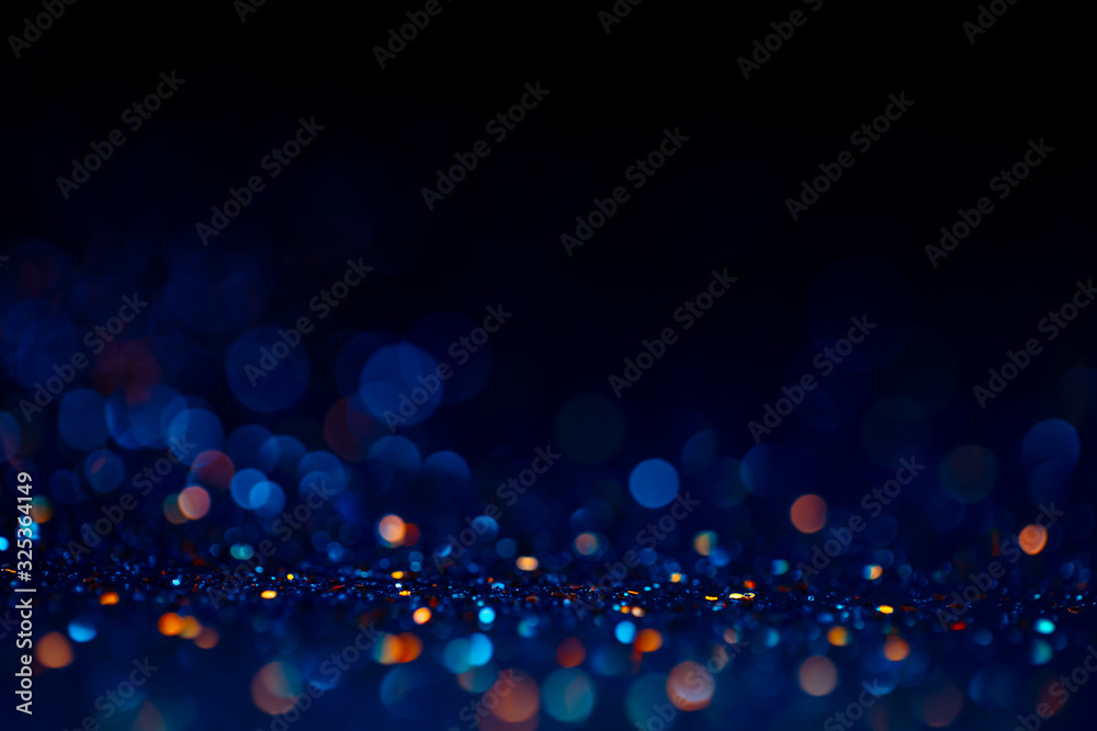Decoration twinkle lights background, abstract glowing backdrop with circles,modern design wallpaper with sparkling glimmers. Black, blue and golden backdrop glittering sparks with blur effect