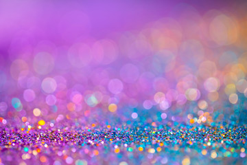 Decoration twinkle glitters background, abstract blurred backdrop with circles,modern design overlay with sparkling glimmers. Blue, purple and golden backdrop glittering sparks with glow effect