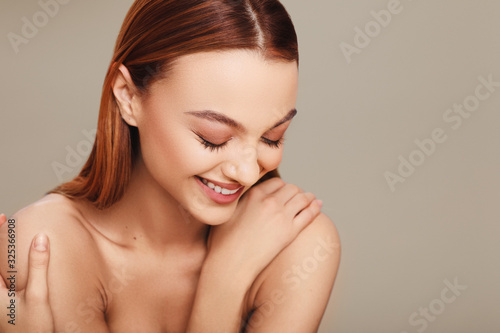 Portrait of a young woman with a beautiful smile in studio