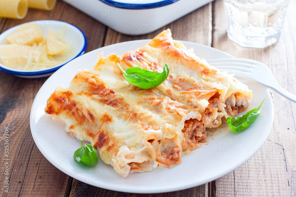 Baked cannelloni with minced meat with bechamel sauce, selective focus Baked cannelloni with minced meat with bechamel sauce, selective focus