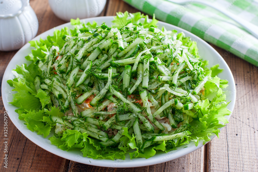 Norwegian salad salad of canned fish and fresh cucumber, selective focus Norwegian salad salad of canned fish and fresh cucumber, selective focus