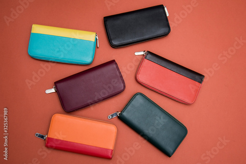 design leather female clutches isolated on orange background