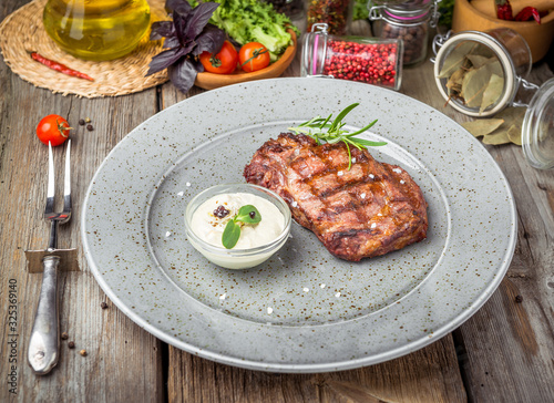 Tenderloin steak on plate with sauce photo