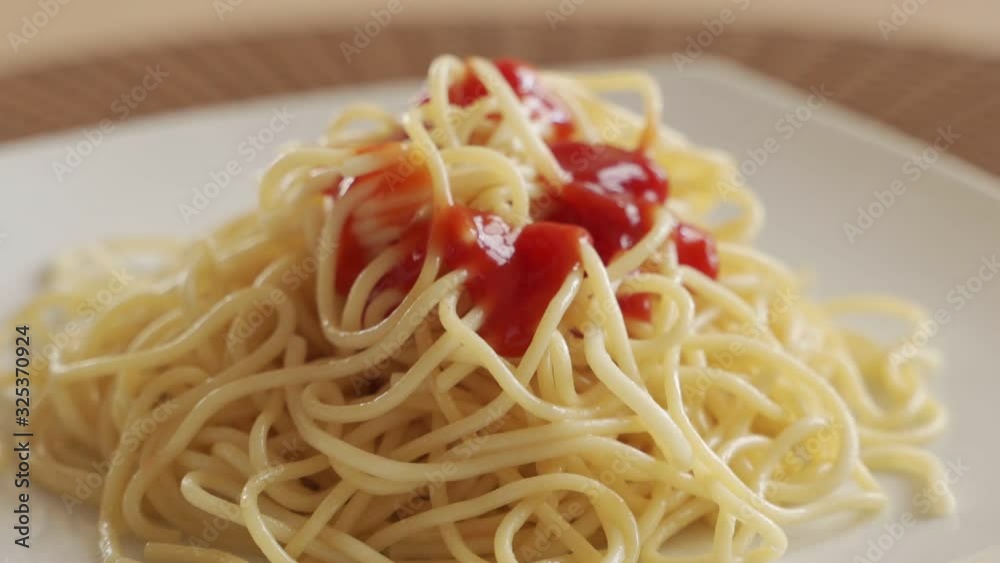 Pouring tomato ketchup on hot spaghetti smoke. Close up. Pouring tomato ketchup on hot spaghetti smoke. Close up.