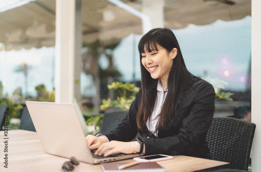 Business Asian woman working on computer outdoor - Happy Chinese girl using laptop in office - Professional job and people lifestyle technology concept Business Asian woman working on computer outdoor - Happy Chinese girl using laptop in office - Professional job and people lifestyle technology concept