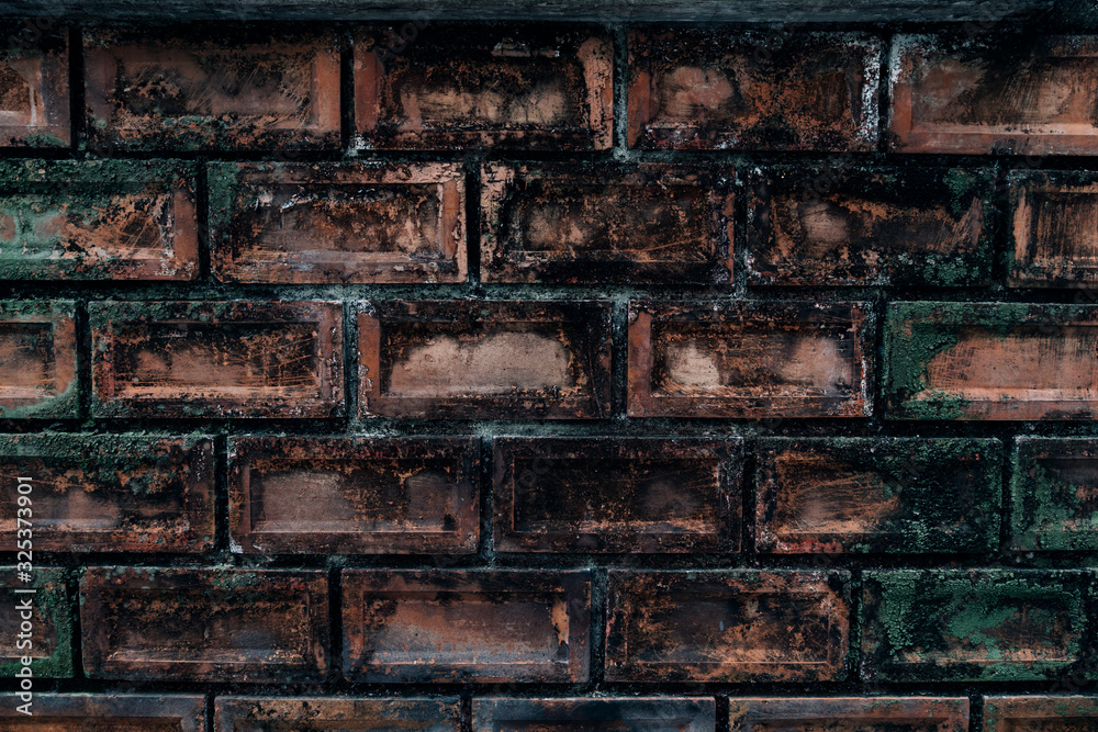 Art of green nature on the red-orange brick wall