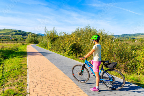 Young woman tourist on Velo Dunajec cycling road near Nowy Sacz, Poland photo