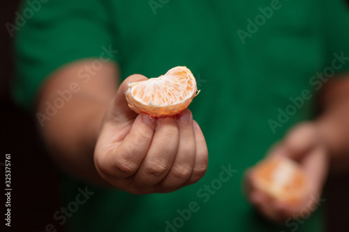 A slice of tangerine in the hands