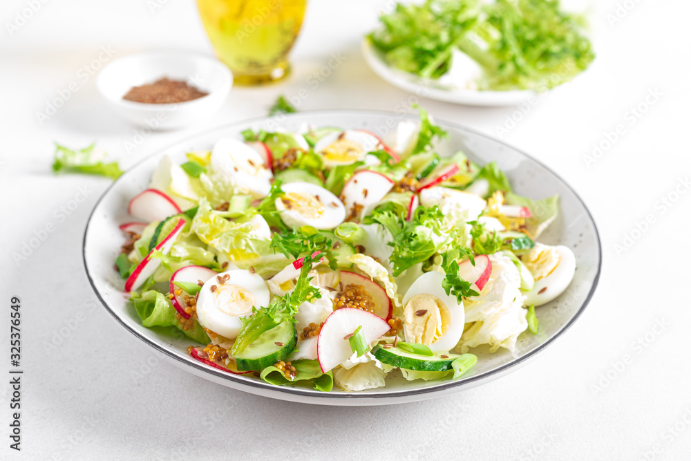 Fresh vegetable salad with cucumber, radish, lettuce and boiled eggs. Helathy food. Top view. Flat lay Fresh vegetable salad with cucumber, radish, lettuce and boiled eggs. Helathy food. Top view. Flat lay
