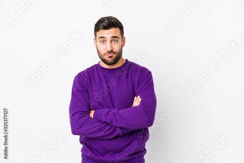 Young caucasian man against a white background isolated unhappy looking in camera with sarcastic expression. © Asier