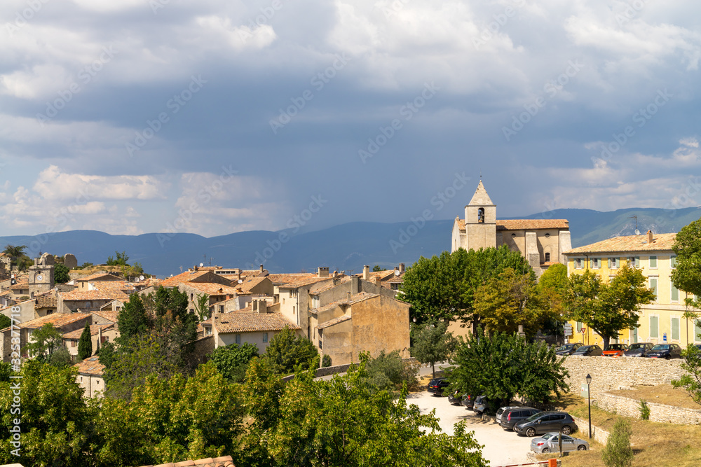Rain clouds over the old town of Saignon, Provence, France