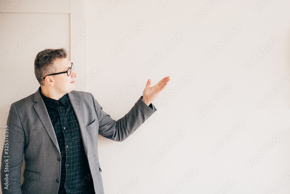 Successful businessman in modern office, pointing on copy space. Business, professional occupation and career Successful businessman in modern office, pointing on copy space. Business, professional occupation and career