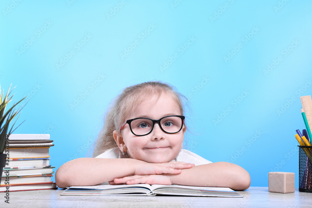 Back to school .Happy cute industrious child is sitting at a desk indoors. Kid is learning in class. Back to school .Happy cute industrious child is sitting at a desk indoors. Kid is learning in class.