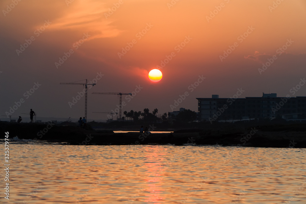 Lots of construction cranes near Ayia Napa in Cyprus on sunset. Lots of construction cranes near Ayia Napa in Cyprus on sunset.