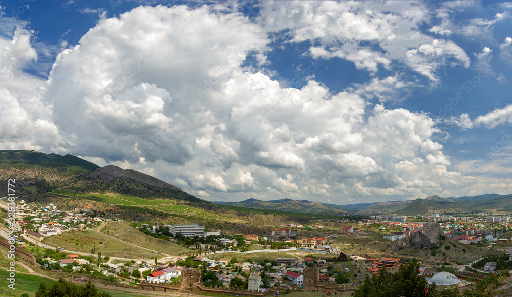The picturesque view of small town at foot of mountains. Beautiful mountain landscape. Sudak, Crimea. 