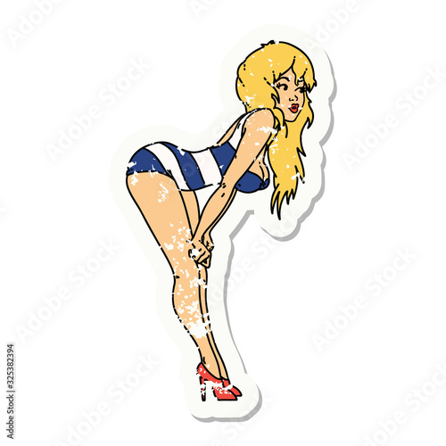 distressed sticker tattoo of a pinup girl in swimming costume