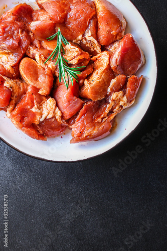 raw meat pork or beef in a plate on the table (preparing healthy food, marinade and spices paprika) menu concept background. top view. copy space