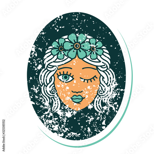distressed sticker tattoo style icon of a maiden with crown of flowers winking