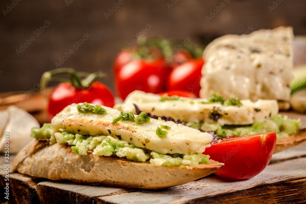 Delicious sandwiches and toasts. The concept of eco products. Vegetarian wholesome food. Parmesan, feta, goat cheese. Background image. Copy space
