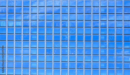 Close-up square office windows, blue glass facade
