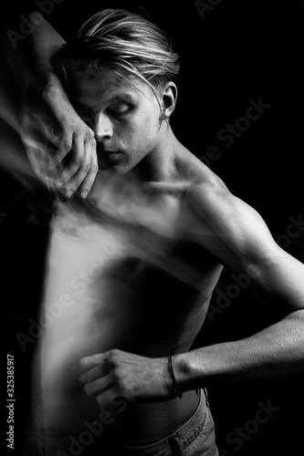 Dramatic emotional creative portrait of a handsome young naked guy. figurative expression of emotions and feelings. Long exposure creative moody creepy art works. Dancer or fighter