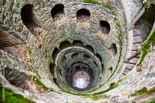 The Initiation well of Quinta da Regaleira It's a 27 meter staircase that leads straight down underground and connects with other tunnels via underground. located in Sintra, Portugal. photo