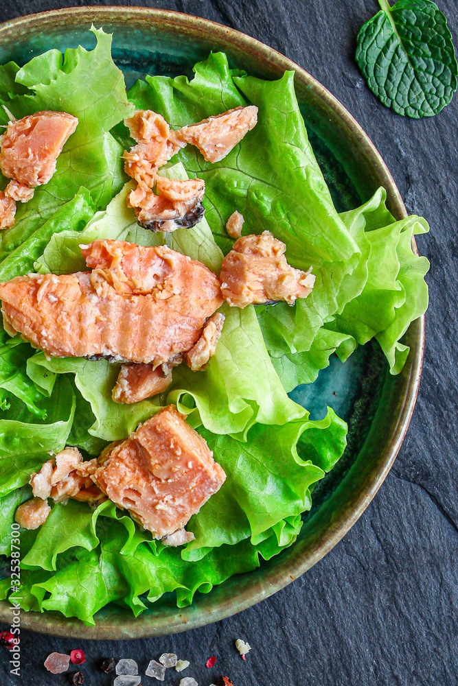 fish salad canned salmon or tuna (lettuce and other ingredients) menu concept background. top view. copy space