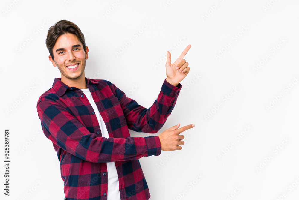 Young caucasian man posing in a pink background isolated excited pointing with forefingers away. Young caucasian man posing in a pink background isolated excited pointing with forefingers away.