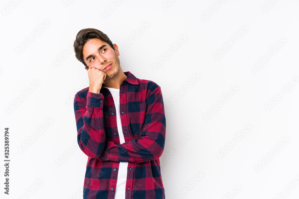 Young caucasian man posing in a pink background isolated who feels sad and pensive, looking at copy space. Young caucasian man posing in a pink background isolated who feels sad and pensive, looking at copy space.