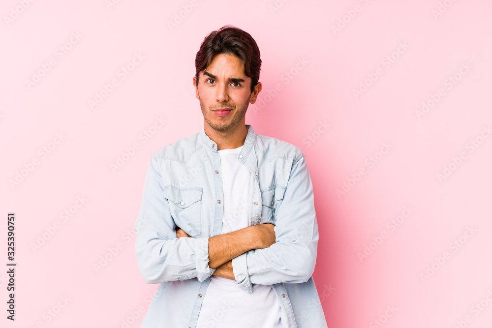Young caucasian man posing in a pink background isolated unhappy looking in camera with sarcastic expression. Young caucasian man posing in a pink background isolated unhappy looking in camera with sarcastic expression.