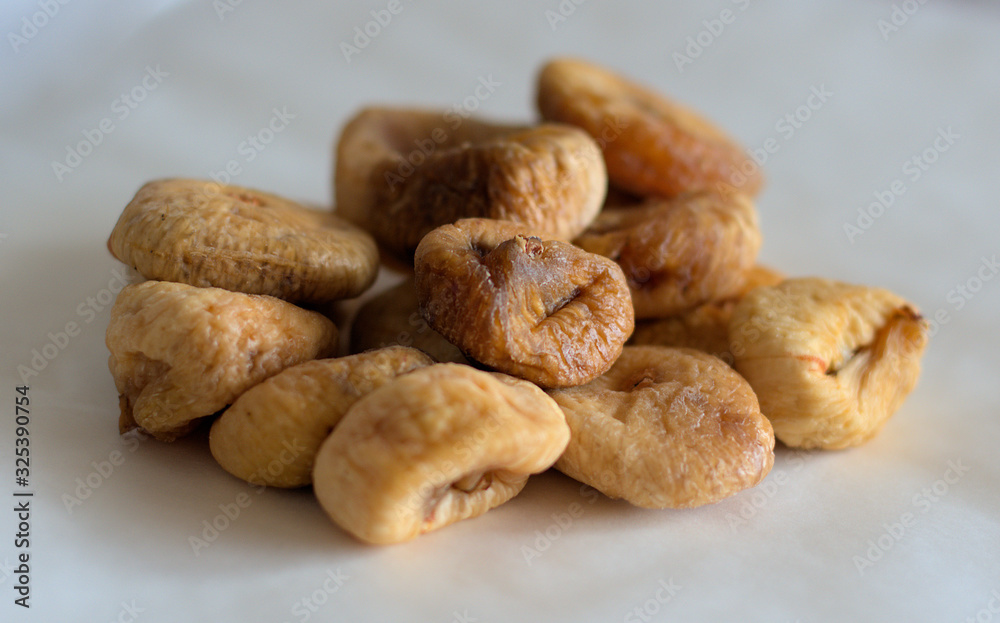 Dried figs chocolates, peanuts and apricots on white background Dried figs chocolates, peanuts and apricots on white background