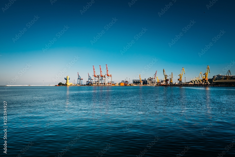 Black Sea trade port, containers loading by crane. International marine shipping. Container import export logistic, cargo harbor view, water transport. Industrial freight. Seaport cranes panorama.