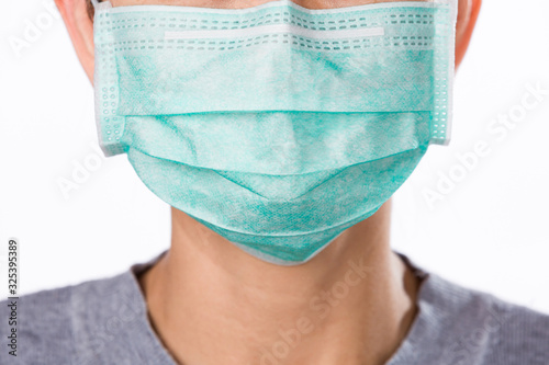 Close up woman wearing surgical mask on white backgeound photo