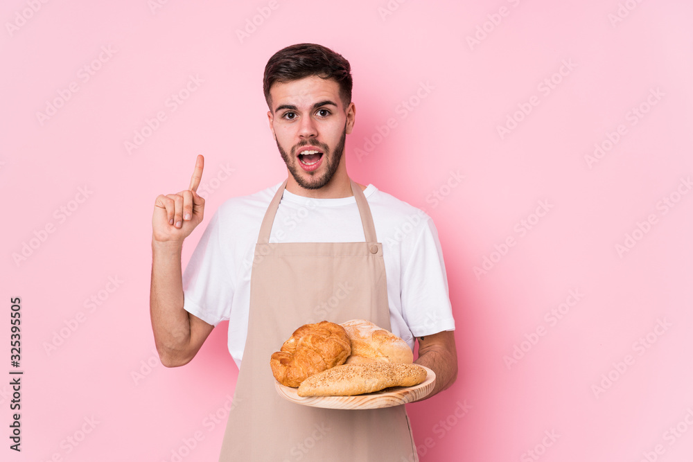 Young caucasian baker man isolated having some great idea, concept of creativity. Young caucasian baker man isolated having some great idea, concept of creativity.