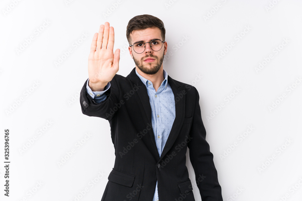 Young caucasian business man posing in a white background isolated Young caucasian business man standing with outstretched hand showing stop sign, preventing you. Young caucasian business man posing in a white background isolated Young caucasian business man standing with outstretched hand showing stop sign, preventing you.