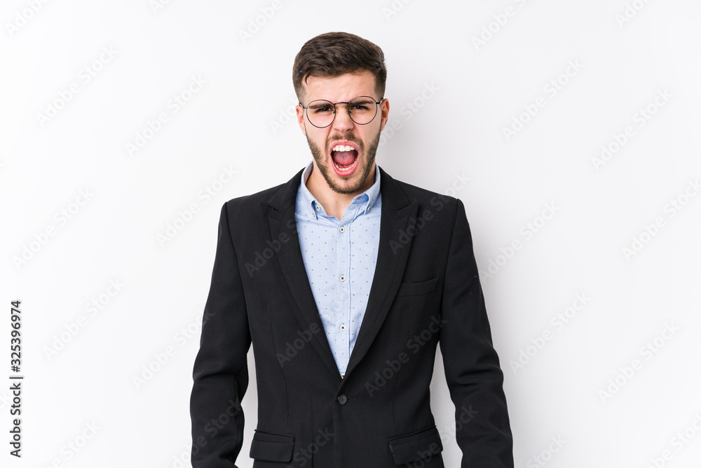 Young caucasian business man posing in a white background isolated Young caucasian business man screaming very angry and aggressive. Young caucasian business man posing in a white background isolated Young caucasian business man screaming very angry and aggressive.