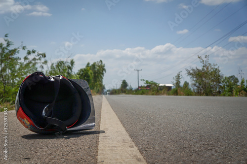 Helmet falls due to accident, driving safety concept photo