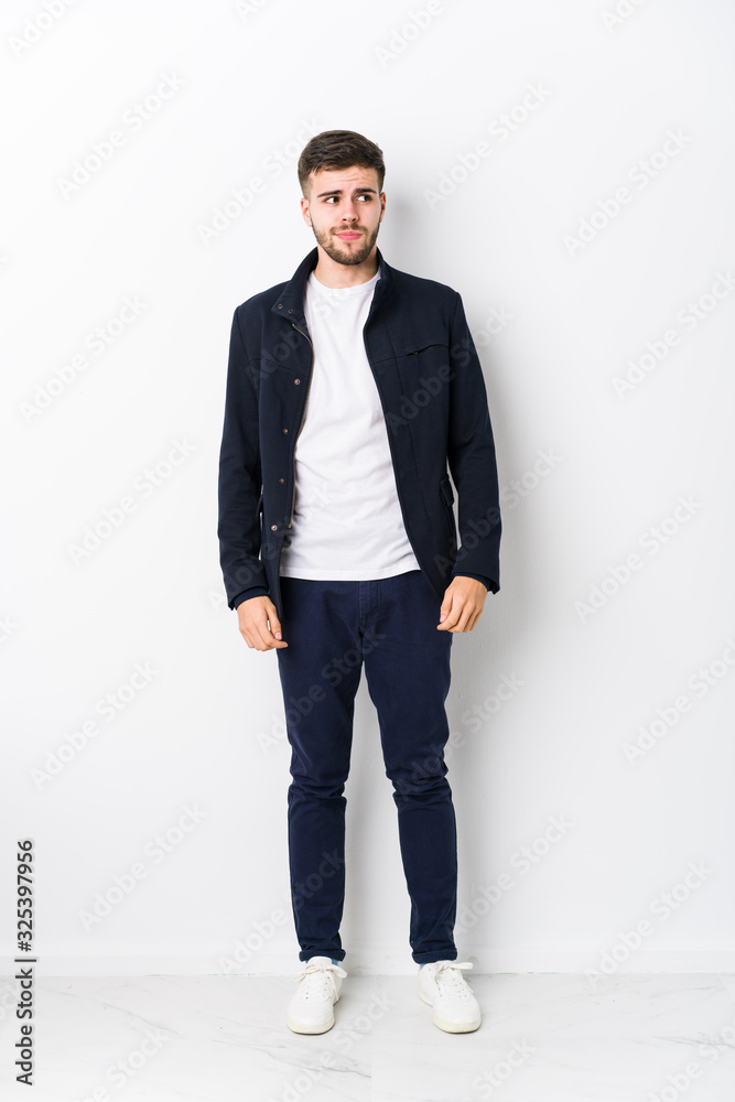 Full body young caucasian man isolated confused, feels doubtful and unsure. Full body young caucasian man isolated confused, feels doubtful and unsure.