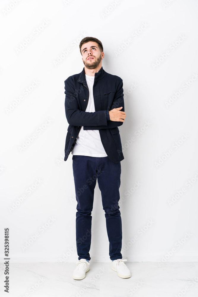 Full body young caucasian man isolated tired of a repetitive task. Full body young caucasian man isolated tired of a repetitive task.