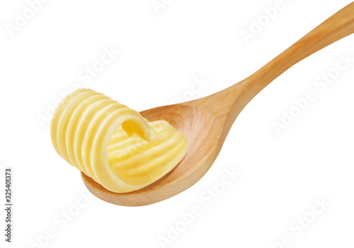 Butter curls or butter rolls on wooden spoon isolated. photo