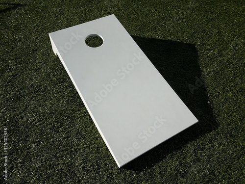 white board with hole for beanbag toss on grass Fototapet