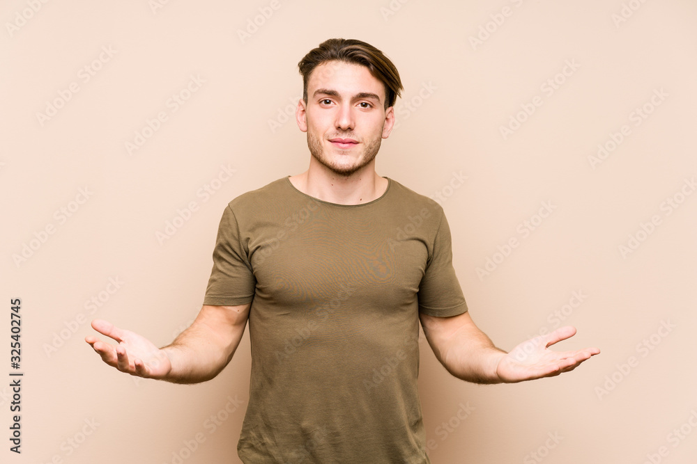 Young caucasian man posing isolated showing a welcome expression. Young caucasian man posing isolated showing a welcome expression.
