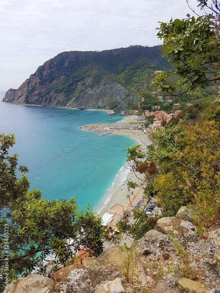 Italy, Cinque Terre, Monterosso Al Mare. Beautiful view of a coast line with greenery, turquoise sea and rocks