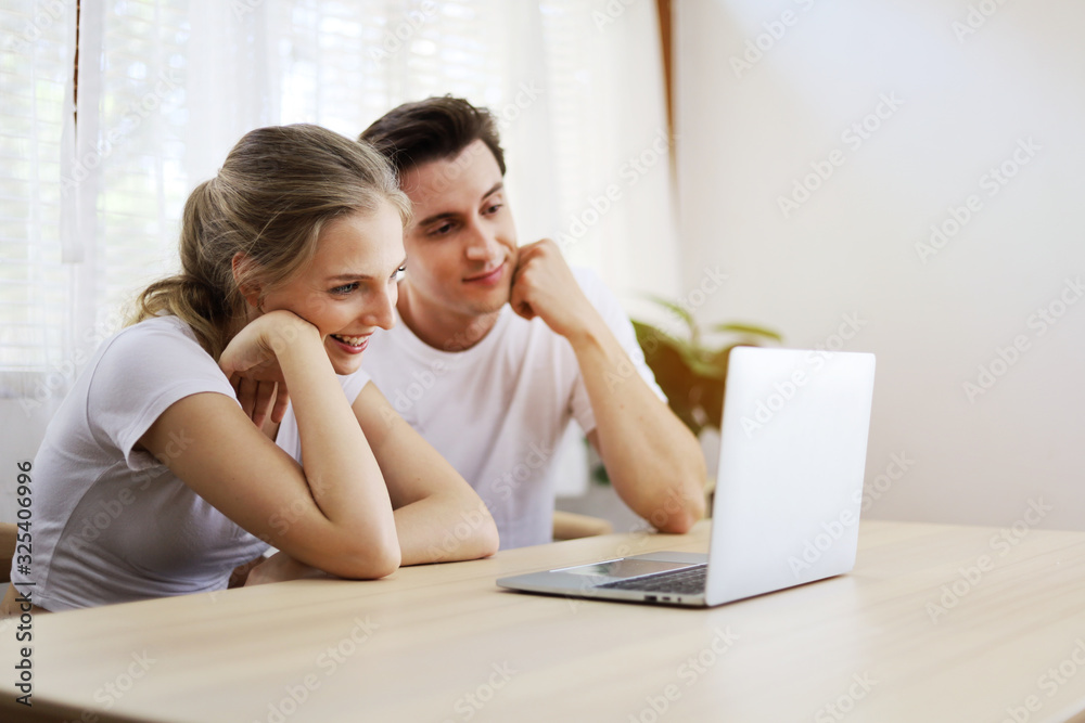 Happy couple lover talking and waving hand in a video conference on line with a laptop for contact friendship at home. Happy couple lover talking and waving hand in a video conference on line with a laptop for contact friendship at home.