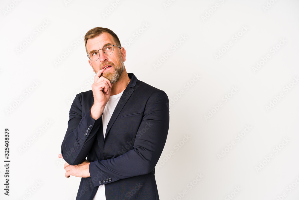 Senior business man isolated on white background relaxed thinking about something looking at a copy space. Senior business man isolated on white background relaxed thinking about something looking at a copy space.