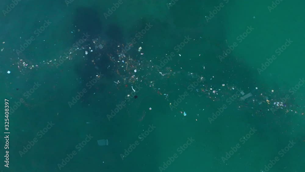 Ocean water and plastic trash, aerial view. Top view of paradise island